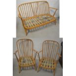 A retro Ercol stick-back three-piece suite comprising two-seater sofa,