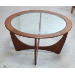 A retro G-Plan circular coffee table with glass top on stylised crossed base, diameter 86cm.