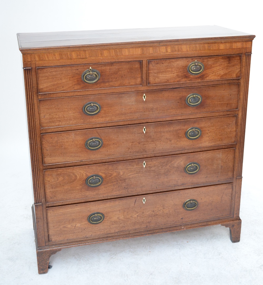 An early 20th century mahogany chest of drawers with crossbanded and inlaid frieze,