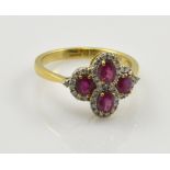 A 9ct yellow gold dress ring with four pink oval stones set within borders of white sapphire chips,