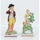 An early 19th century Staffordshire figure of a gentleman wearing a hat and carrying a large cup,