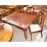 An Edwardian mahogany rectangular table with turned legs two replacement leaves and four mahogany