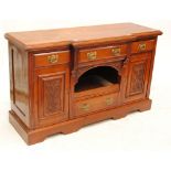 A walnut break front sideboard with three drawers above central compartment flanked by carved