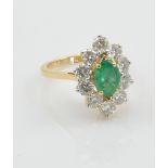 An 18ct yellow gold emerald and diamond ring,