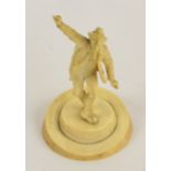 A late 19th/early 20th century German carved ivory figure of a dancing man in traditional clothes,