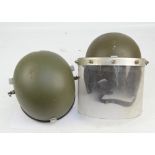 Two Northern Ireland issue riot helmets, one with flip down visor (2).