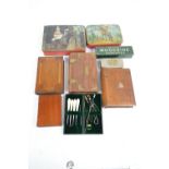 Three mahogany book shaped boxes, a further teak examples, three advertising tins,