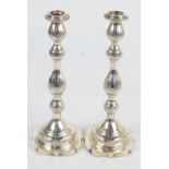 A pair of George V hallmarked silver Shabbat candlesticks with campana shaped and garland embossed