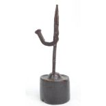 A 17th century wrought iron rush light holder on turned wooden base, height 24.5cm.