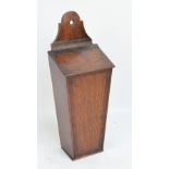 A late George III oak and mahogany crossbanded candle box with leather strap hinge.