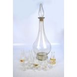 A large apothecary bottle with stopper 81cm, with twelve glass conical flasks.