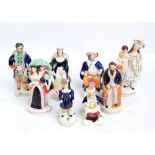 Eight small 19th century Staffordshire figures including a young woman standing holding an exotic