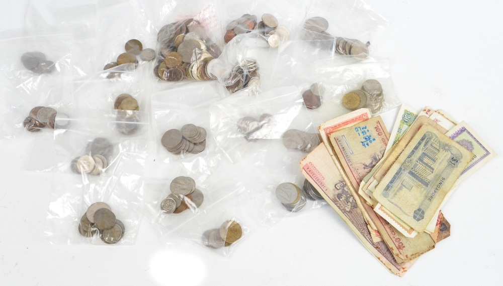 A quantity of foreign coins and notes, including notes from Papua New Guinea, Finland, Singapore,