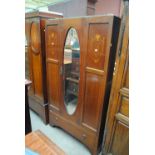 An Edwardian inlaid wardrobe centred with an oval mirror, width 94cm.