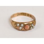 A 9ct rose gold ring set with central coral cabochon, flanked by pearl sprays,