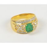 A yellow metal emerald and diamond ring,