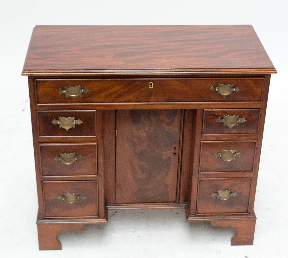 A late 19th/early 20th century mahogany kneehole writing desk with one long drawer,