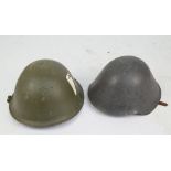 A WWI helmet with leather liner and chin guard and a further helmet with replaced liner (2).