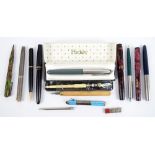 A quantity of pens and pencils including a Parker Duofold red and black marbled pen with 14ct nib,