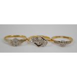 Three 18ct yellow gold rings including a three stone diamond example in triple heart shaped