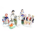 Six 19th century Staffordshire figures/figure groups including a boy seated beside a basket of fish,