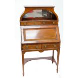 An Edwardian inlaid mahogany bureau with raised mirrored canopy, two drawers, fitted interior,