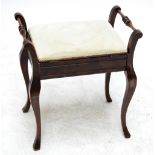 An Edwardian mahogany piano stool with hinged seats, turned spindle sides on cabriole legs,