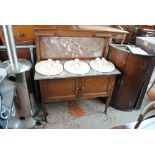 An Edwardian mahogany washstand with grey and white marble top and back over two crossbanded doors,