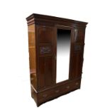 A large late Victorian walnut wardrobe with central mirror door.