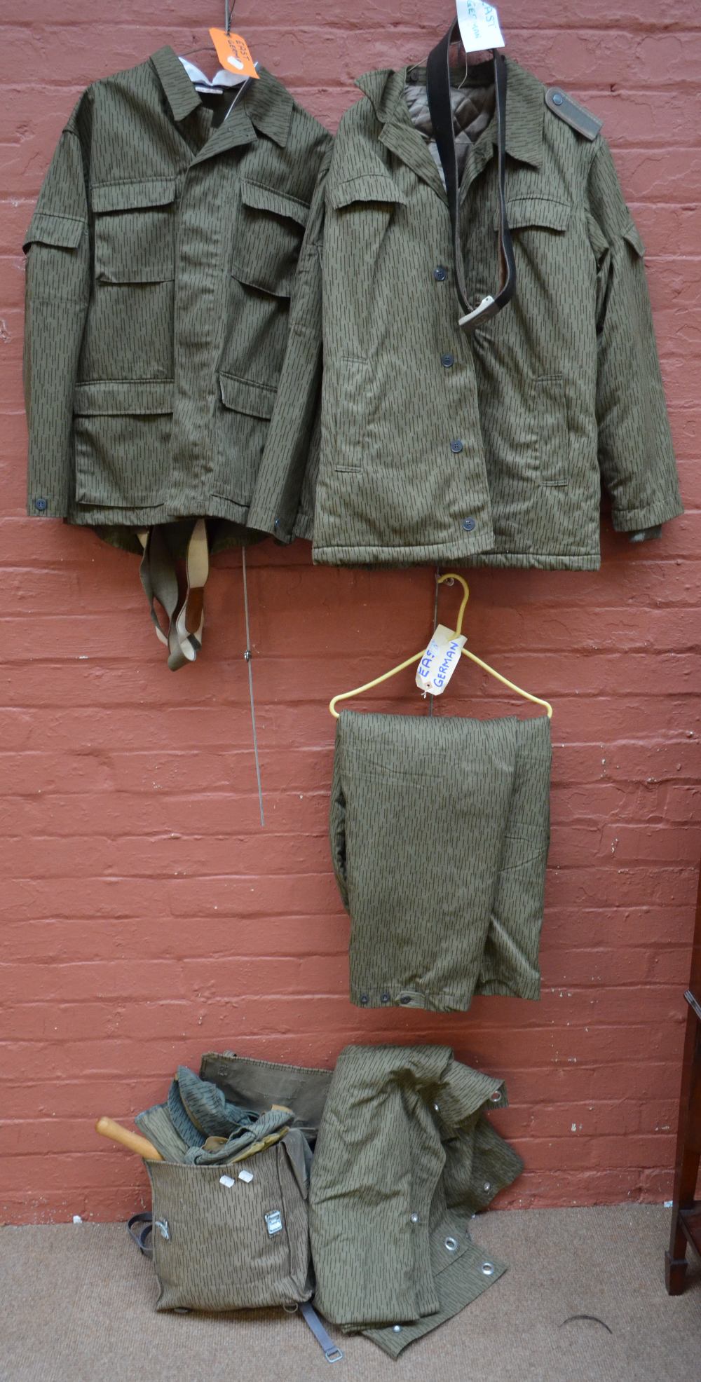 An East German military lightweight jacket with detachable collar and trousers with suspenders,