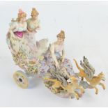 A late 19th century Sitzendorf porcelain figure group of three women in floral decorated chariot