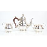 ADIE BROS; a George V hallmarked silver three piece tea set, Birmingham 1924, height of teapot 20cm,