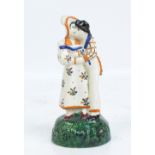 An early 19th century Prattware figure group 'Lovers', bearing traces of paper label to base,