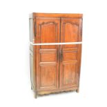 An early 19th century French fruitwood armoire with twin panelled doors.