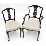Four Edwardian mahogany dining chairs with pierced splat back and stuff-over seats,
