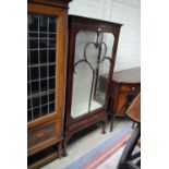 A mahogany glazed display cabinet with lower drawer raised on cabriole legs to ball and claw feet,