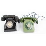 A mid 20th century black bakelite revolving dial telephone and a green plastic example (2).