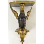 A 19th century gilt and ebonised wall bracket modelled as a seated griffin, width 30cm (af).