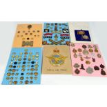 A collection of military insignia including cap badges, a large quantity of buttons, fabric badges,