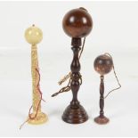 Three 19th century cup and ball games, one with floral carved ivory shaft,