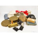 Two military tin hats, a cloth cap, cloth beret, various other clothing, books relating to the RAF,