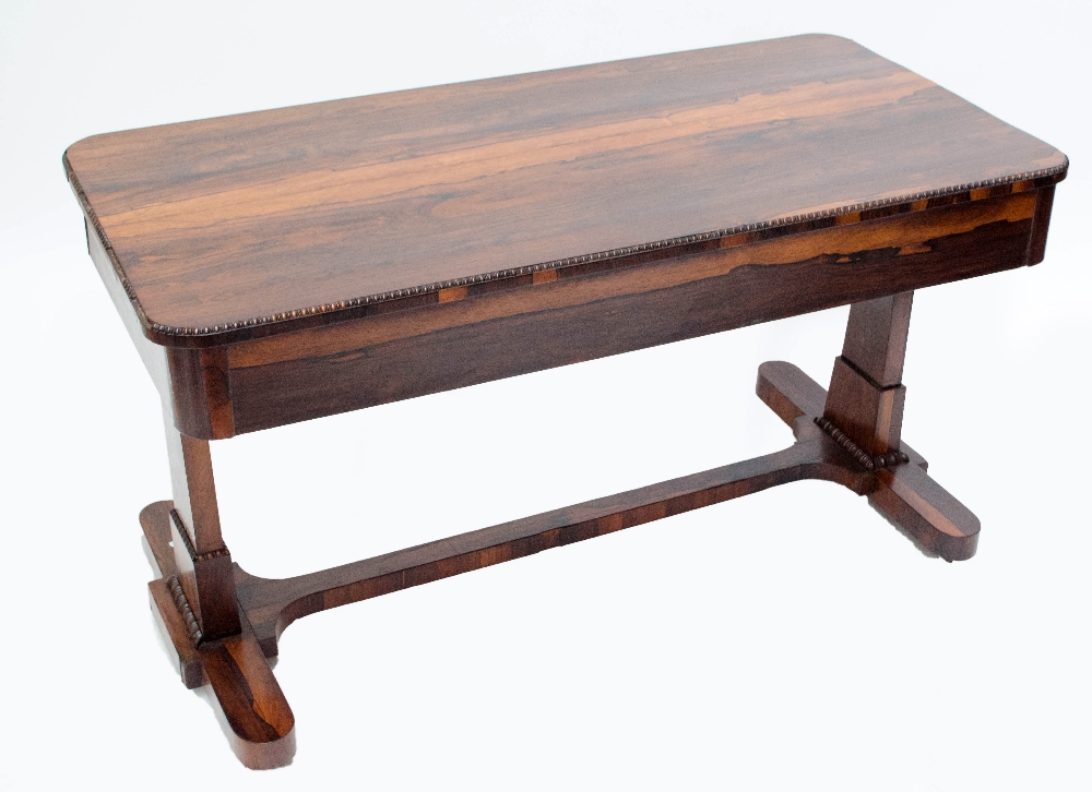 A 19th century rosewood library table with beaded decoration, two short drawers, to tapering legs,