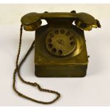 A 1930s novelty tin cigarette dispenser modelled as a telephone with a lighter set in the receiver,