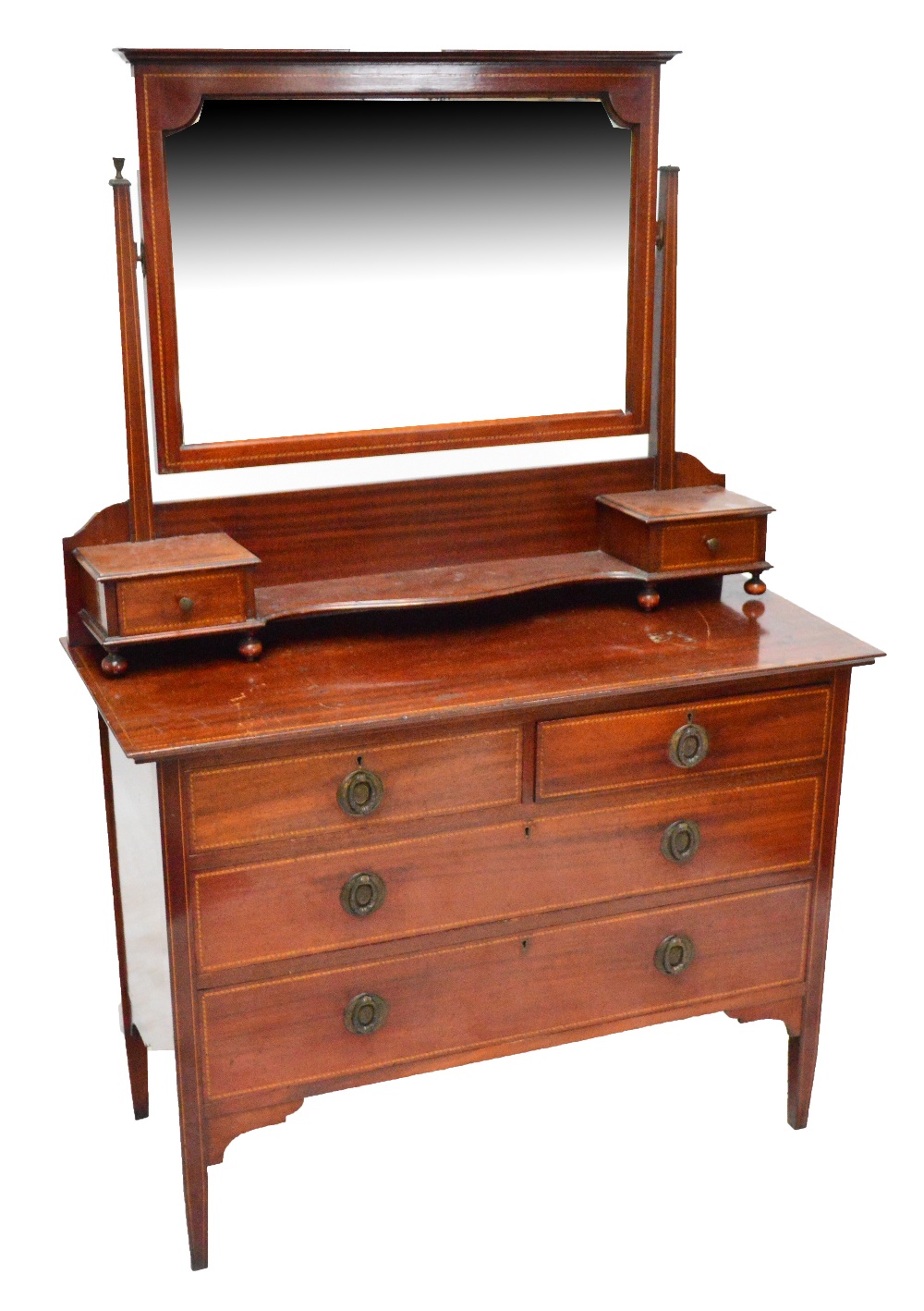 An Edwardian three piece bedroom suite comprising mahogany wardrobe with cornice top,