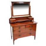 An Edwardian three piece bedroom suite comprising mahogany wardrobe with cornice top,