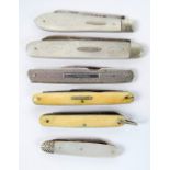 A small collection of pocket knives including three early 20th century examples with mother of