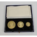 A cased 1963 John F Kennedy three gold graduated coin set.