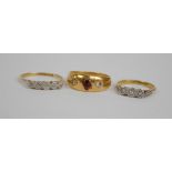 An Edwardian 18ct yellow gold ring set with ruby coloured stone and one diamond, (one missing),