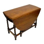 An early 20th century oak oval dropleaf dining table on barleytwist gateleg supports,