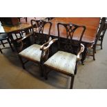 A set of eight reproduction mahogany dining chairs with pierced bar shaped backs and padded drop-in